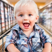 baby in a grocery store cart