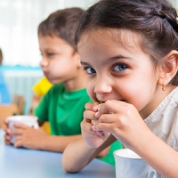 Cute little children drinking milk